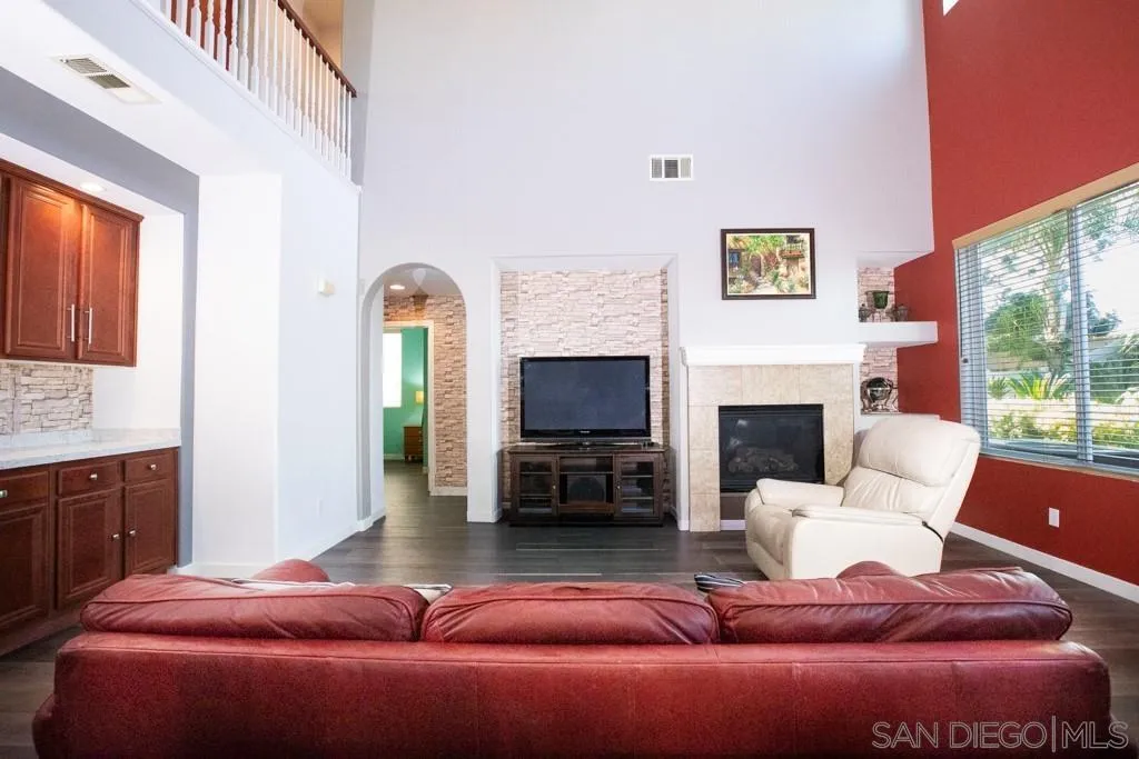 31340 Locust Court Temecula, CA 92592 - Photo 7 of 24 a living room with furniture a fireplace and a flat screen tv