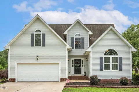a view of a white house with large windows