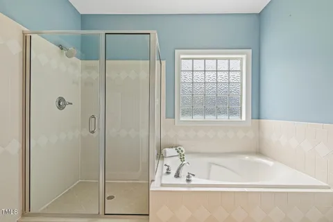 a bath tub sitting next to a shower
