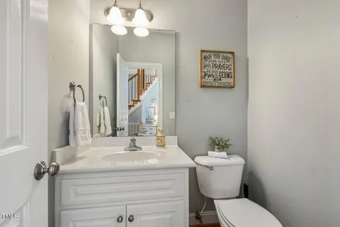 a bathroom with a sink mirror and toilet
