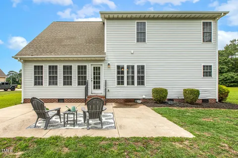 a view of a house with swimming pool and sitting area