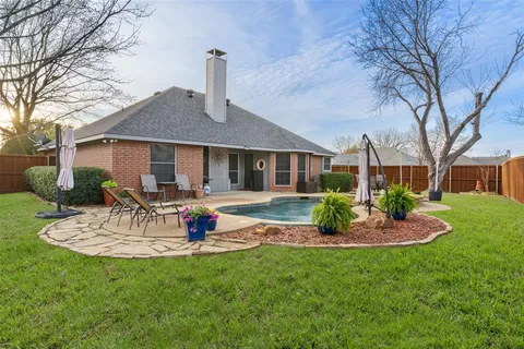 a view of a house with backyard sitting area and garden