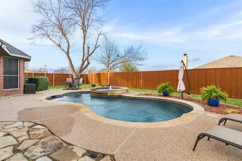 a view of a backyard with a garden and trees