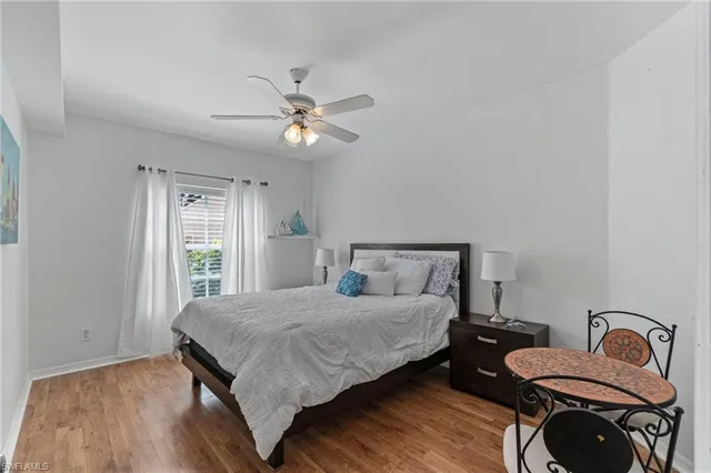 a bedroom with a bed chandelier and a window