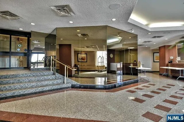 a view of a lobby with black carpet