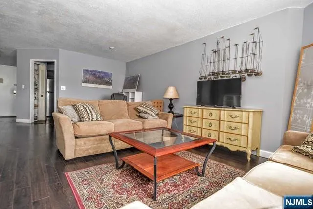 a living room with furniture a rug and a table