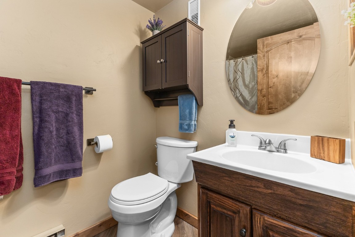 1945 Cornice Road, Unit 101D Steamboat Springs, CO 80487 - Photo 16 of 33 Bathroom with baseboard heating, toilet, vanity, and baseboards
