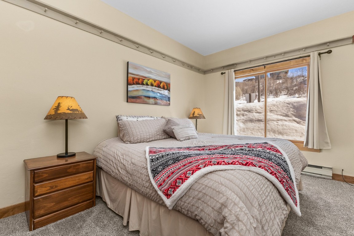 1945 Cornice Road, Unit 101D Steamboat Springs, CO 80487 - Photo 21 of 33 Carpeted bedroom featuring baseboards and a baseboard radiator