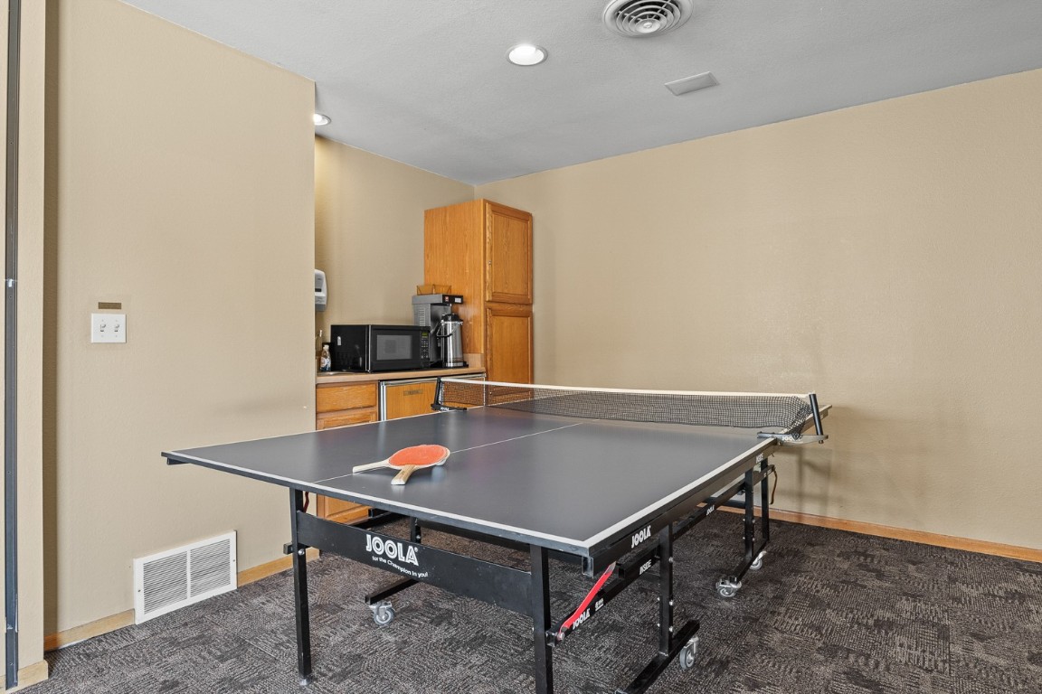 1945 Cornice Road, Unit 101D Steamboat Springs, CO 80487 - Photo 26 of 33 Rec room with visible vents, baseboards, and dark carpet
