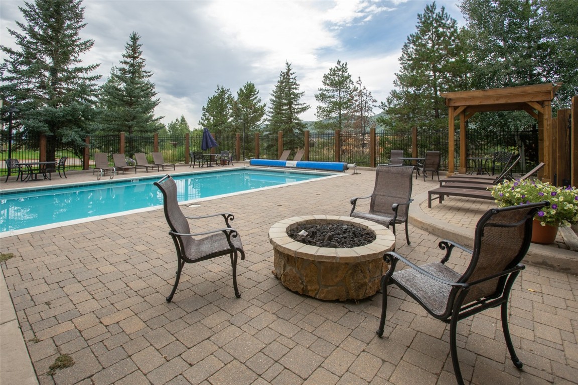 1945 Cornice Road, Unit 101D Steamboat Springs, CO 80487 - Photo 31 of 33 Pool with a patio area, a fire pit, and fence