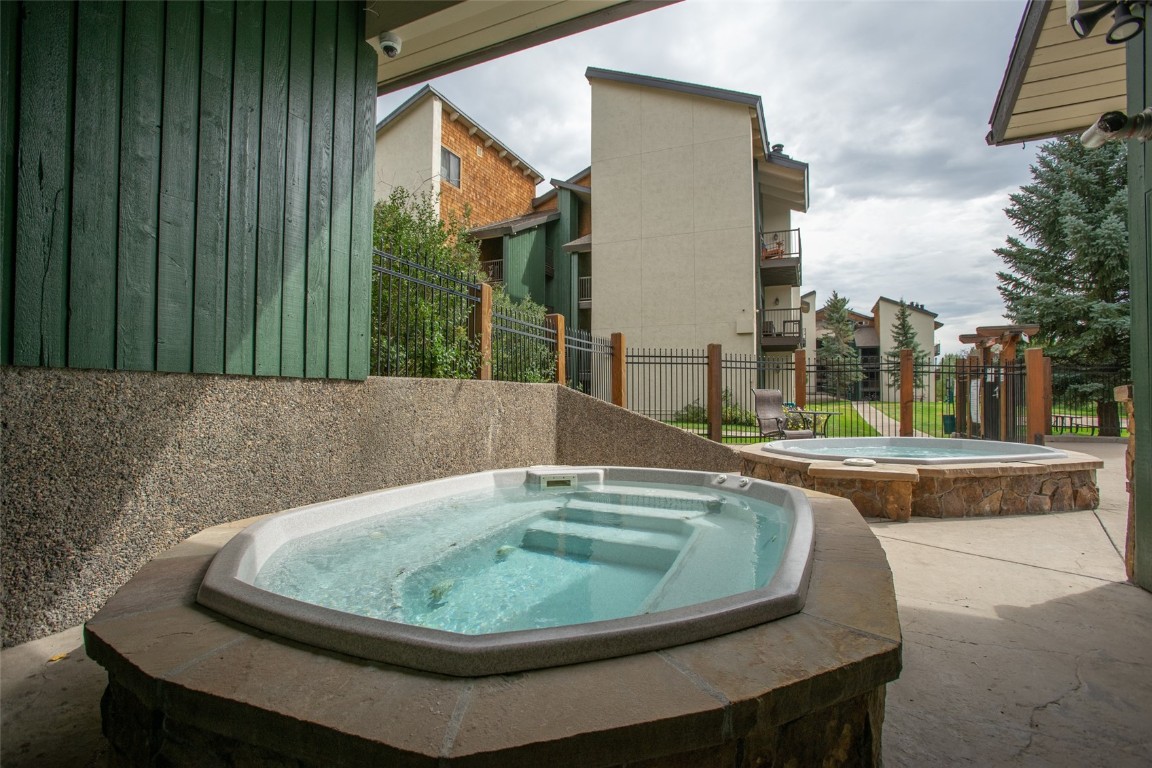 1945 Cornice Road, Unit 101D Steamboat Springs, CO 80487 - Photo 33 of 33 View of pool featuring an in ground hot tub and fence