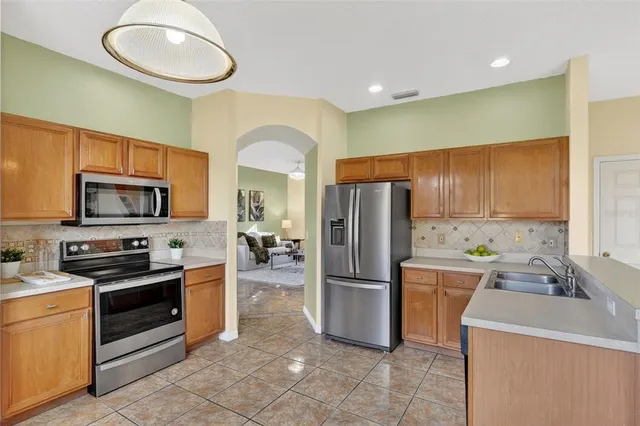 a white toilet sitting next to a white wall