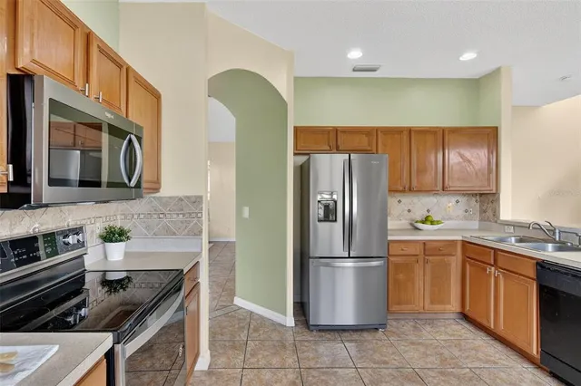 a bedroom with a large bed and windows