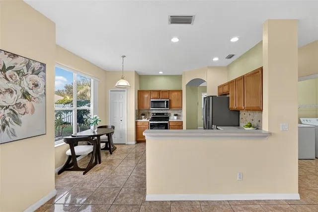 a bathroom with a granite countertop sink a large mirror and a bathtub