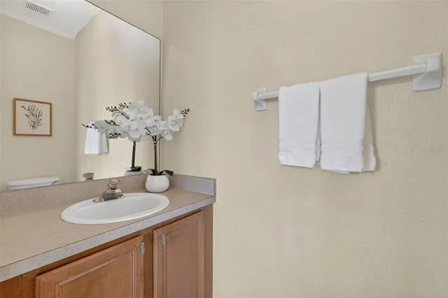 a bedroom with a bed and a ceiling fan