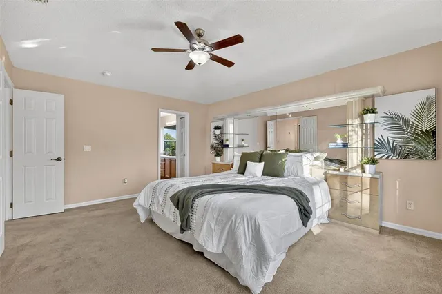 a view of a livingroom with a ceiling fan and refrigerator