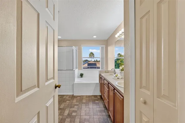 a bath room with a toilet a sink and a large mirror