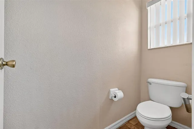a front view of a house with a yard and potted plants