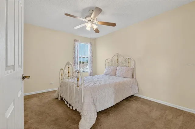 a front view of a house with a yard and potted plants