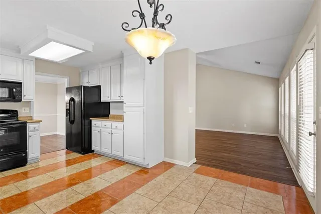 a kitchen with a refrigerator and a sink