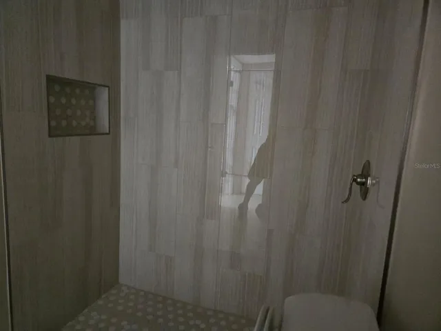 a bathroom with a toilet and a shower