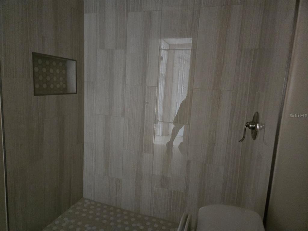 24862 US Highway 19 North, Unit 703 Clearwater, FL 33763 - Photo 20 of 24 a bathroom with a shower curtain