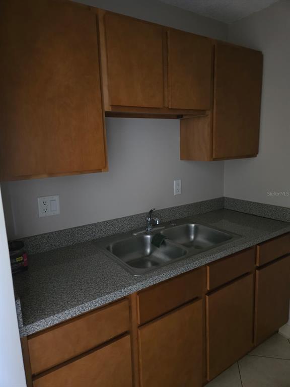 24862 US Highway 19 North, Unit 703 Clearwater, FL 33763 - Photo 9 of 24 a kitchen with granite countertop cabinets and a stove top oven