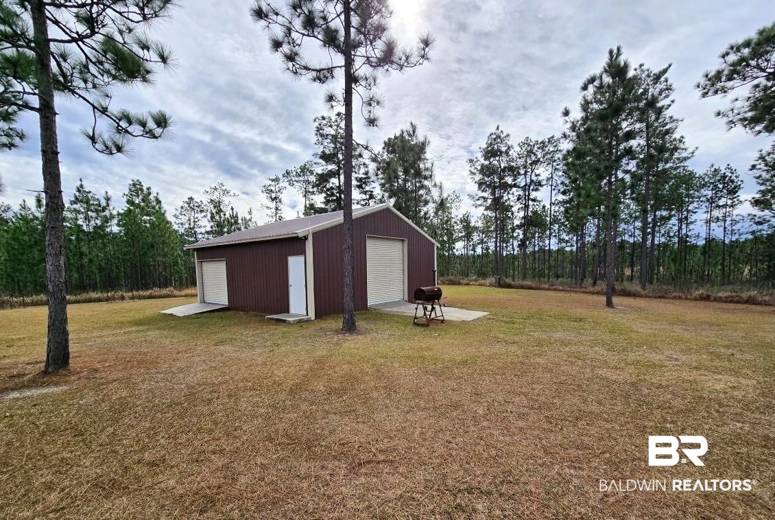 52041 Robert White Road Bay Minette, AL 36507 - Photo 8 of 16 View of yard featuring a garage and an outbuilding