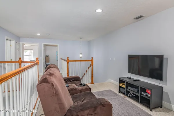 a storage room with washer and ceiling fan
