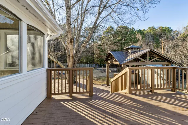 a view of a house with large windows and a wooden floor