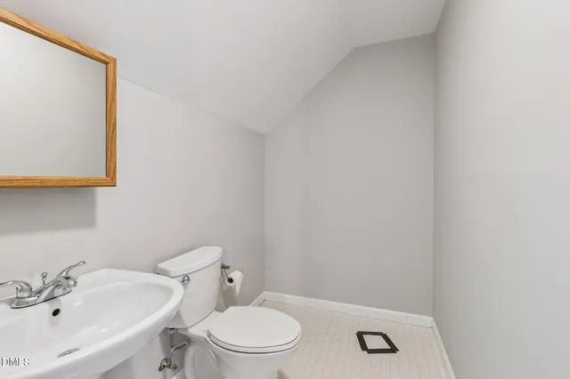 a white toilet sitting next to a white sink