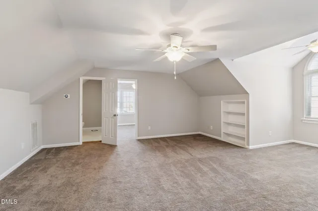 an empty room with a ceiling fan and a ceiling fan