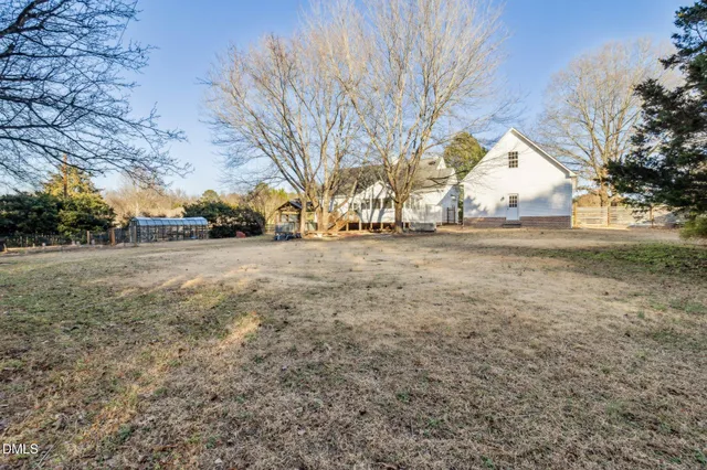 a view of dirt yard with a large tree