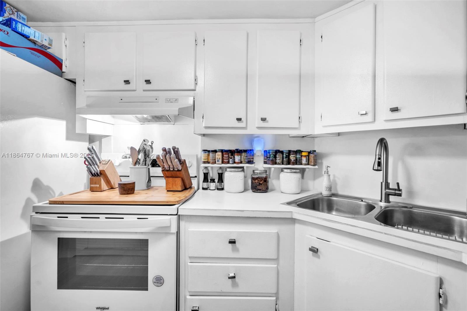 1280 Southeast 2nd Court, Unit 1 Fort Lauderdale, FL 33301 - Photo 11 of 34 a kitchen with white cabinets and white appliances