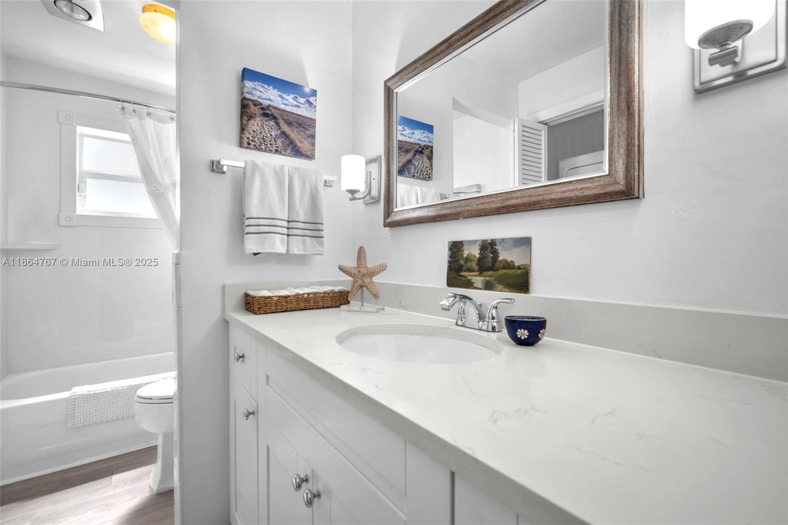 1280 Southeast 2nd Court, Unit 1 Fort Lauderdale, FL 33301 - Photo 17 of 34 a bathroom with a sink a tub and a mirror