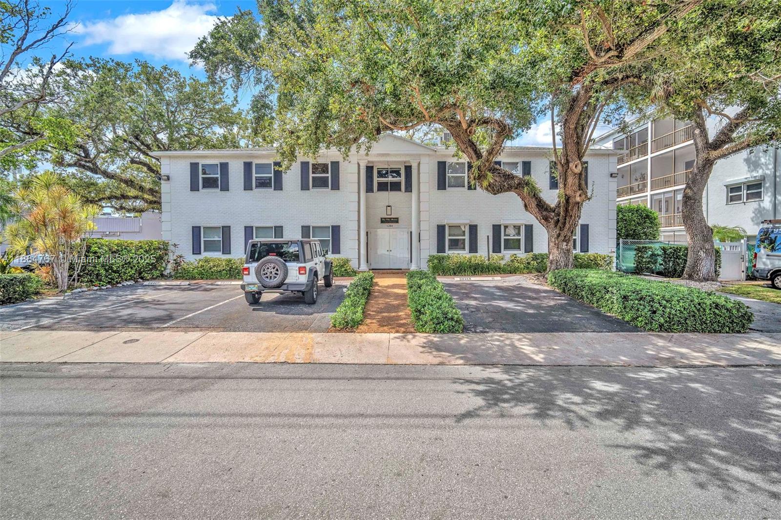 1280 Southeast 2nd Court, Unit 1 Fort Lauderdale, FL 33301 - Photo 3 of 34 a front view of a house with a garden and trees