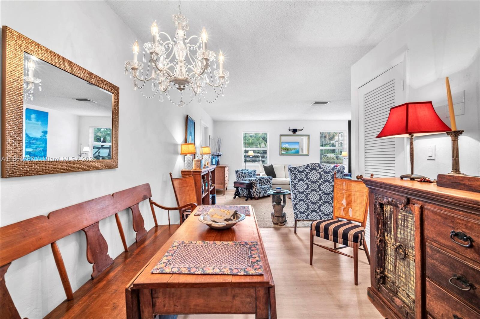 1280 Southeast 2nd Court, Unit 1 Fort Lauderdale, FL 33301 - Photo 8 of 34 a very nice looking dining room with furniture a chandelier and wooden floor