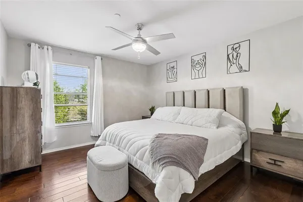 a spacious bedroom with a bed and a window