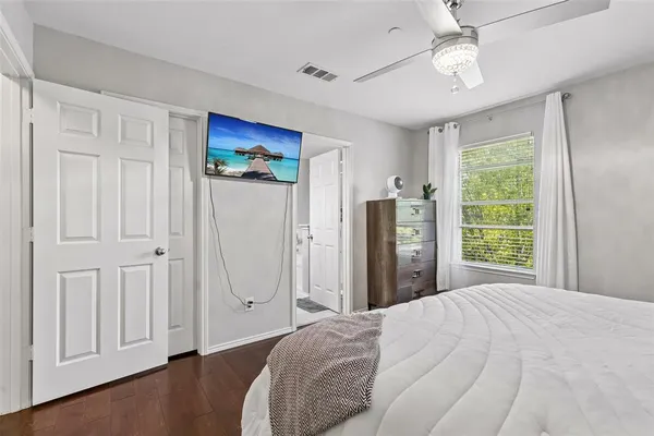 a bedroom with a large bed and a window