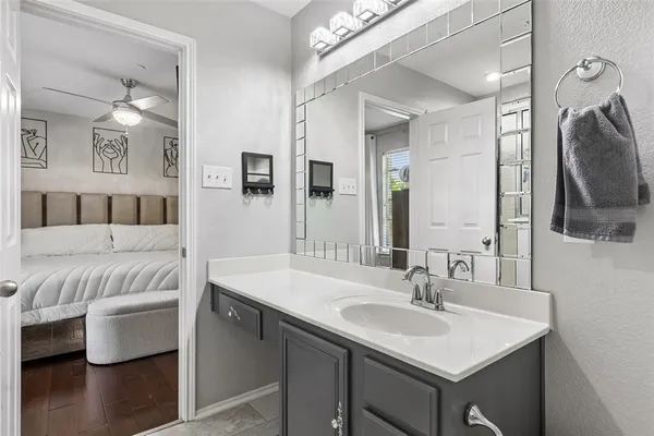 a en suite bathroom with a sink double vanity and a mirror
