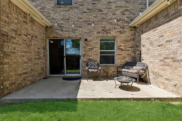 a view of a patio with table and chairs with wooden fence and plants