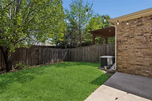 a view of a backyard with chairs and a garden