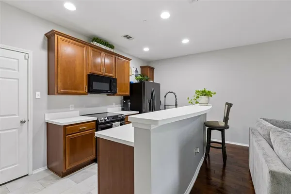 a kitchen with stainless steel appliances a stove microwave and refrigerator