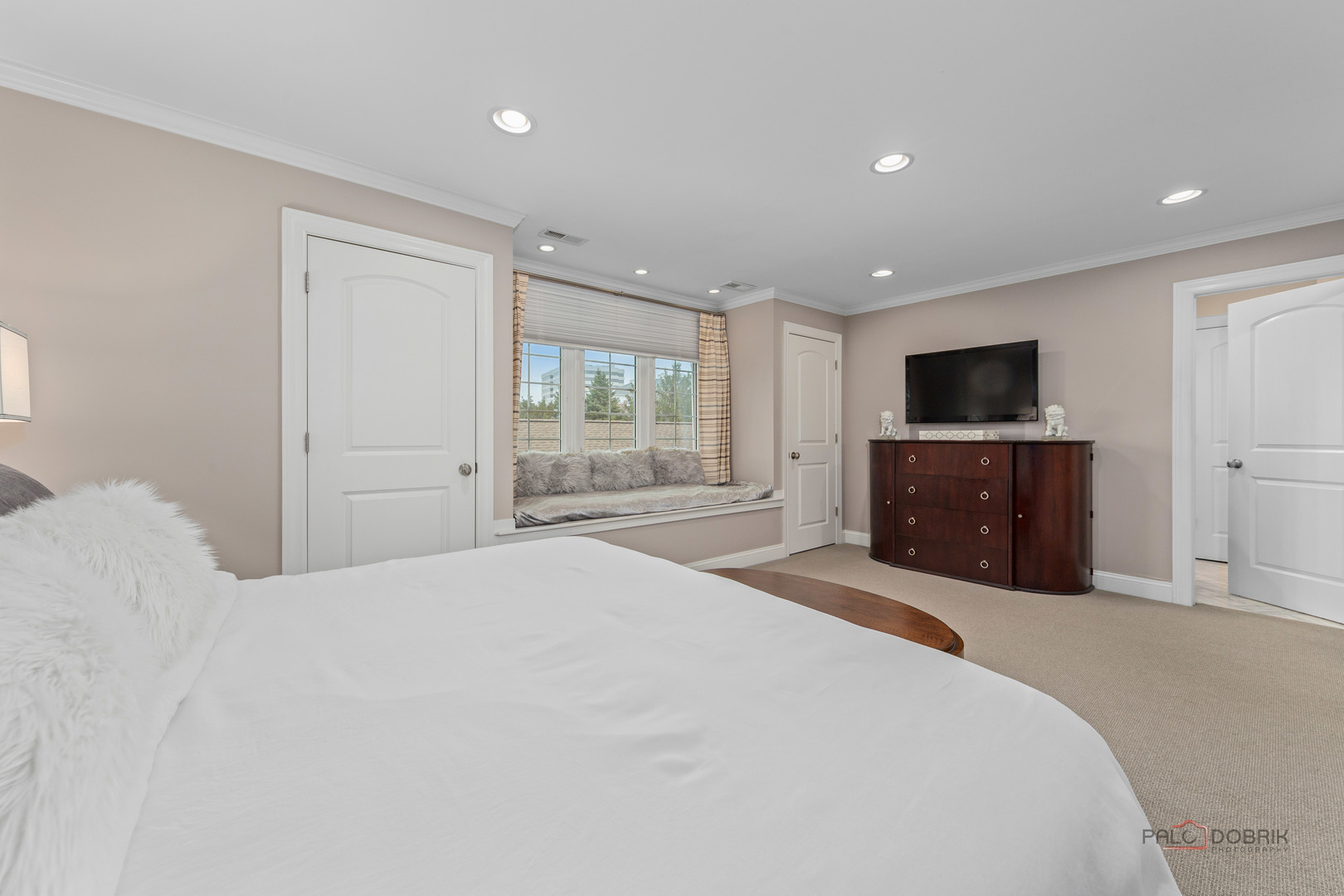 2 North Tower Road Oak Brook, IL 60523 - Photo 23 of 40 a large bedroom with a bed and a television
