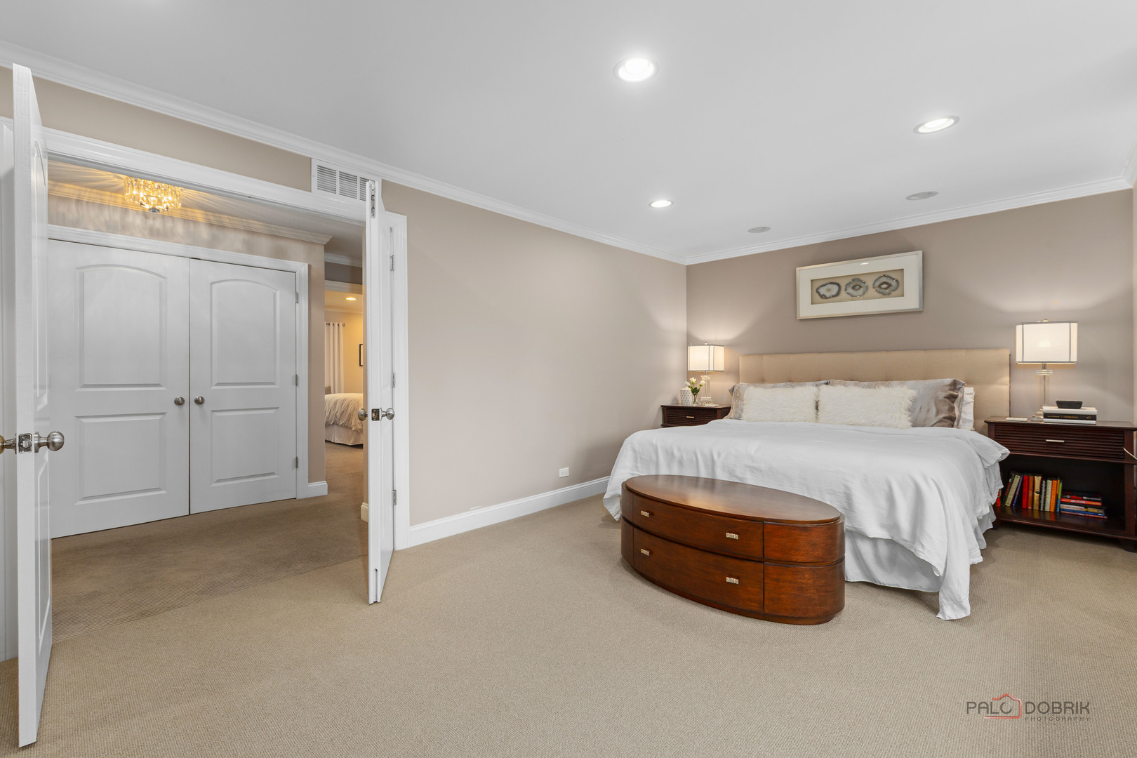 2 North Tower Road Oak Brook, IL 60523 - Photo 24 of 40 a spacious bedroom with a bed and a lamp