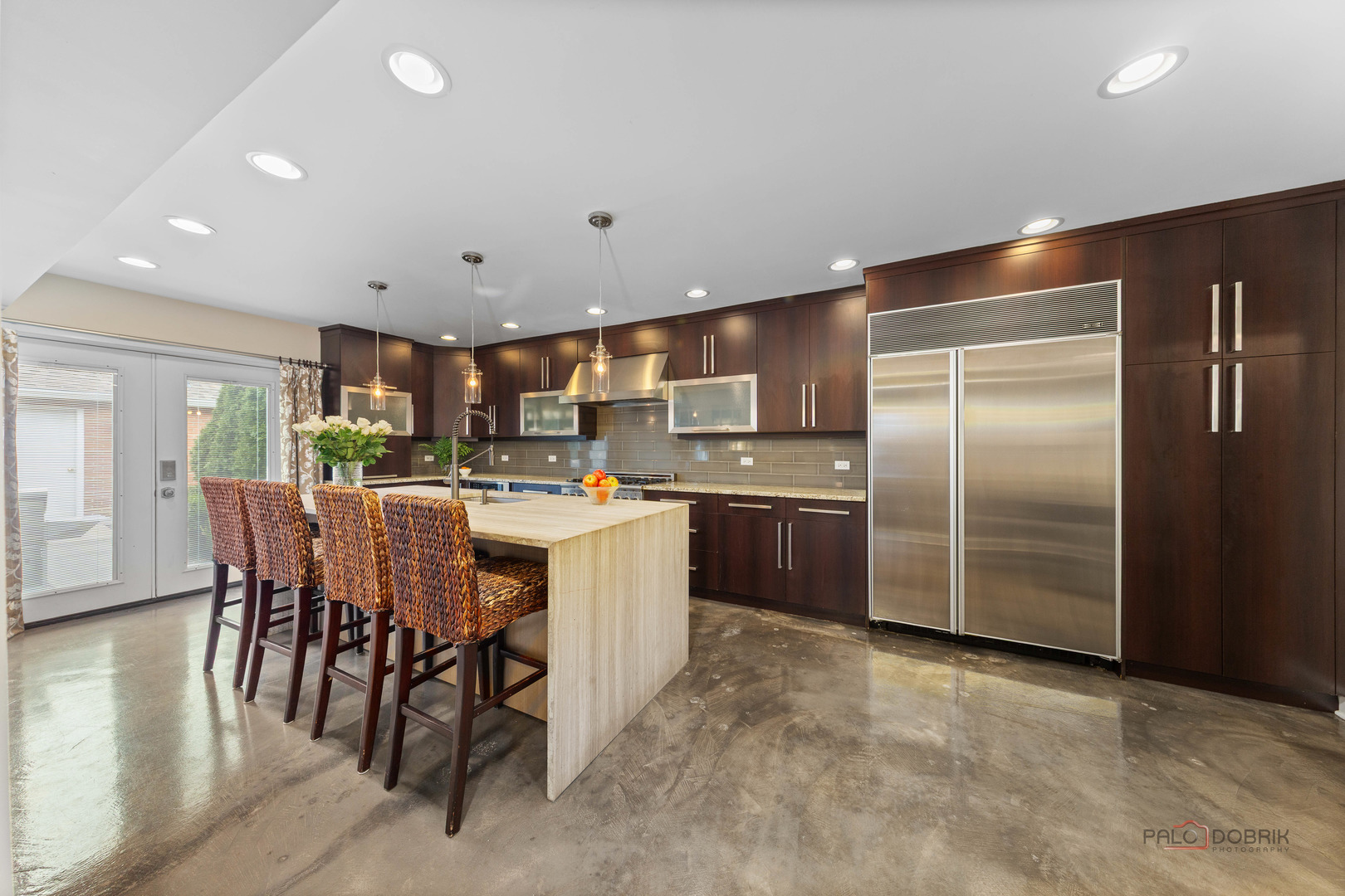 2 North Tower Road Oak Brook, IL 60523 - Photo 7 of 40 a kitchen with stainless steel appliances kitchen island granite countertop a refrigerator a stove a sink a dining table and chairs