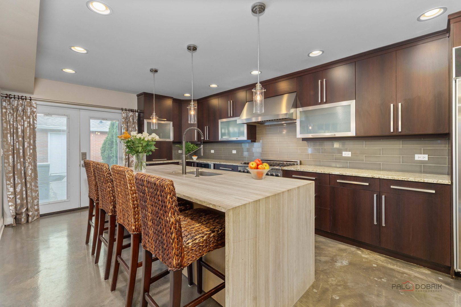 2 North Tower Road Oak Brook, IL 60523 - Photo 8 of 40 a kitchen with stainless steel appliances granite countertop a table chairs sink and cabinets