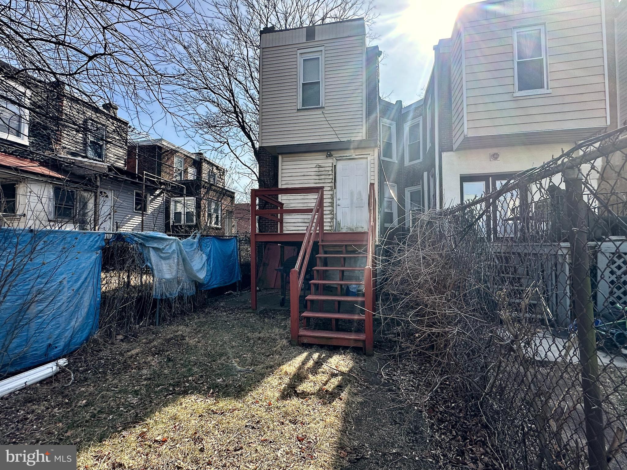 6209 Walnut Street Philadelphia, PA 19139 - Photo 13 of 13 a view of a house with backyard and wooden fence