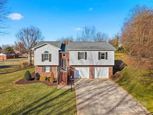 a view of a house with a yard patio and fire pit
