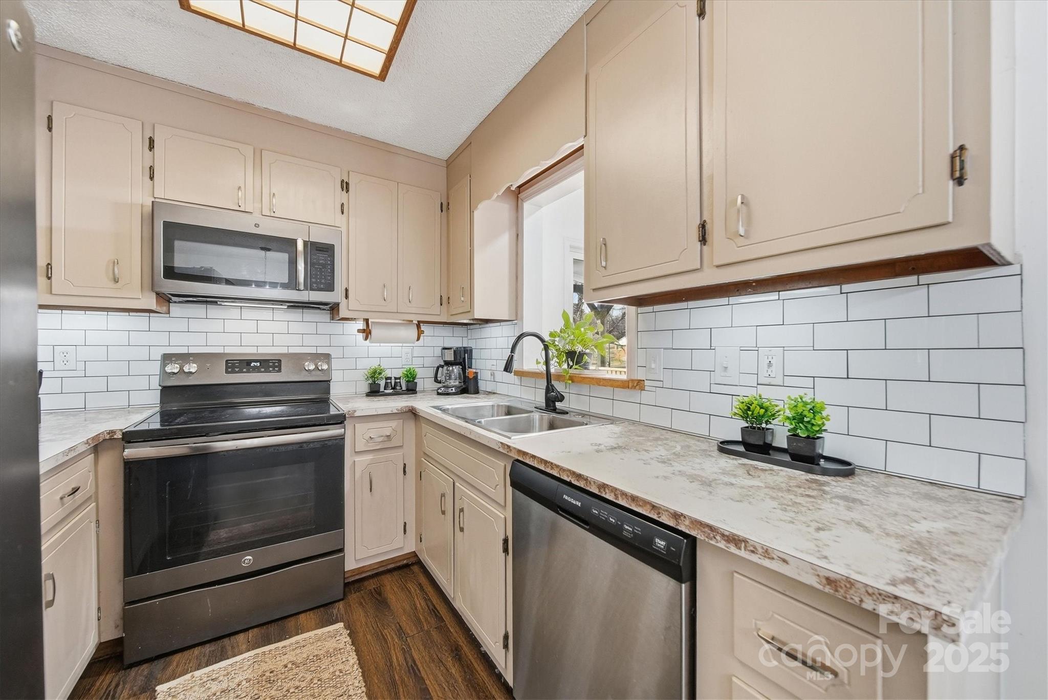 1007 Millbrook Place Southeast Lenoir, NC 28645 - Photo 14 of 46 a kitchen with stainless steel appliances granite countertop a sink stove and microwave
